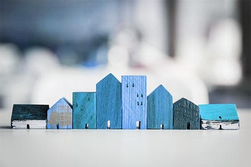 A row of blue wooden model buildings